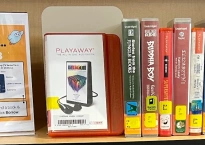 image shows a portion of our audiobook collection at the library